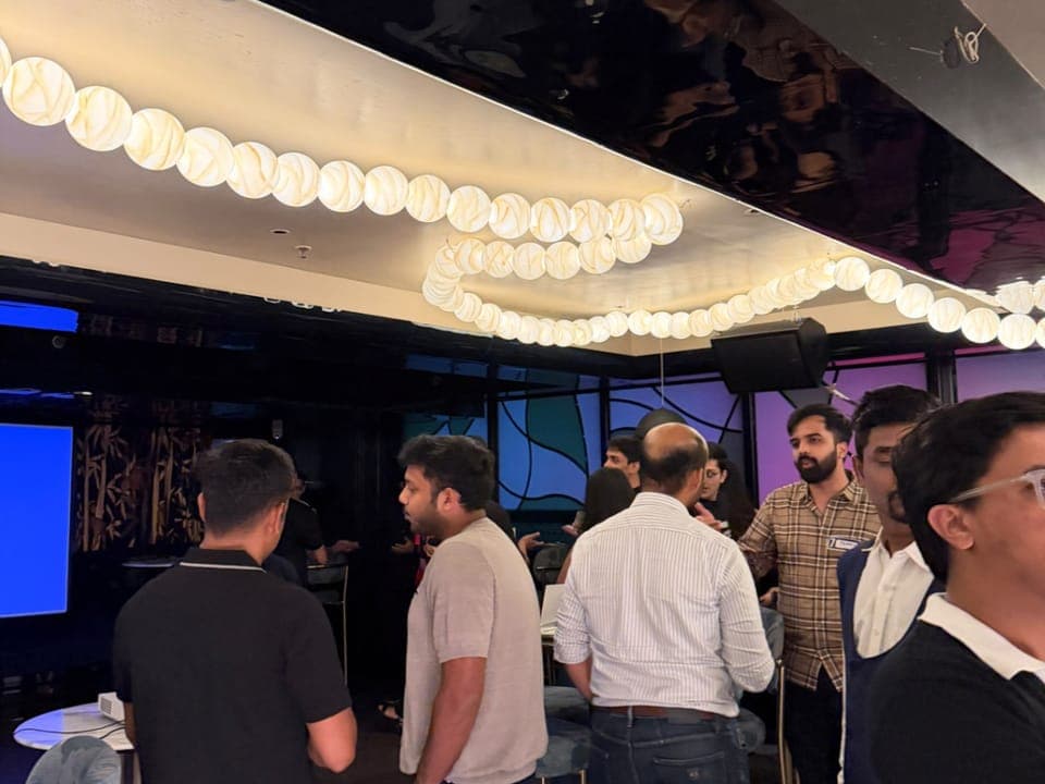 The AI Social: members standing in groups, talking