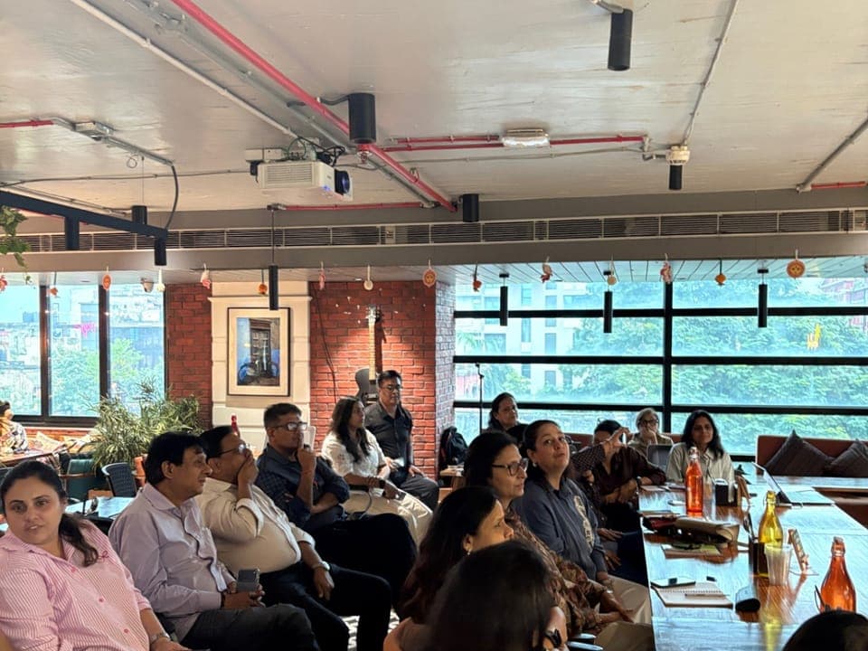 A workshop: a full room at a cafe, listening